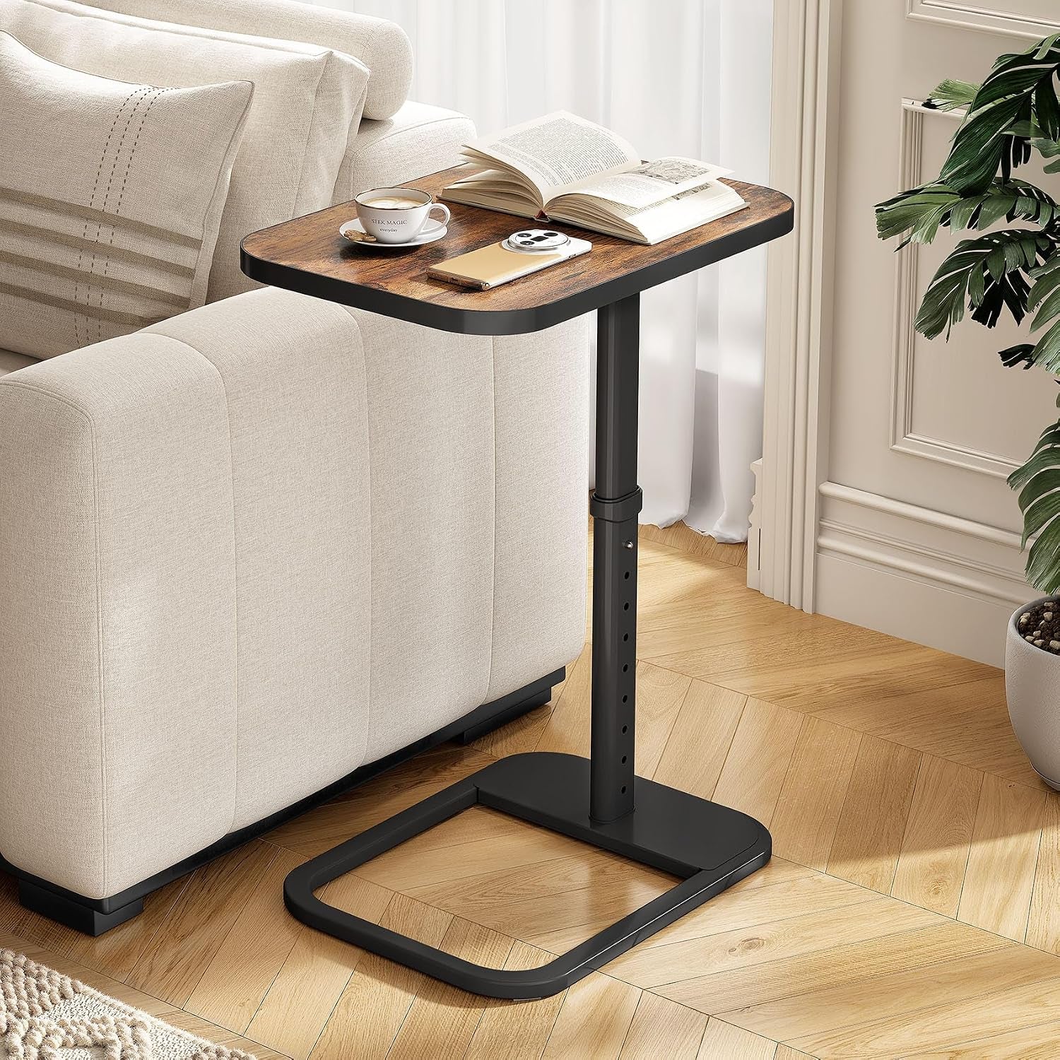 C-shaped side table with brown wood top and black metal base positioned next to a beige sofa