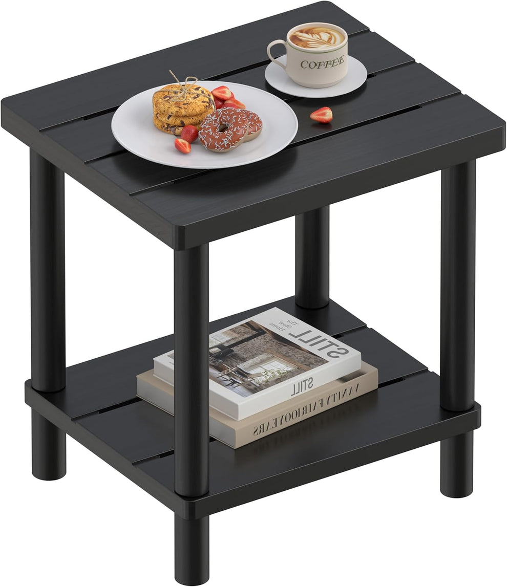 Black bamboo two-tier side table with coffee cup and plate on top and books on lower shelf, angled front view