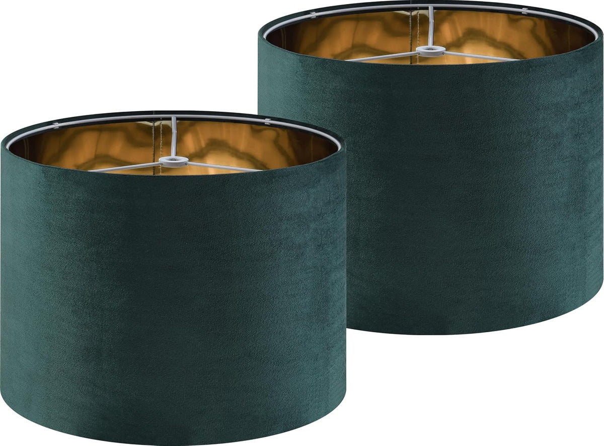Two deep green drum shades overlapping, tops angled to reveal the interior rings and reflective lining.