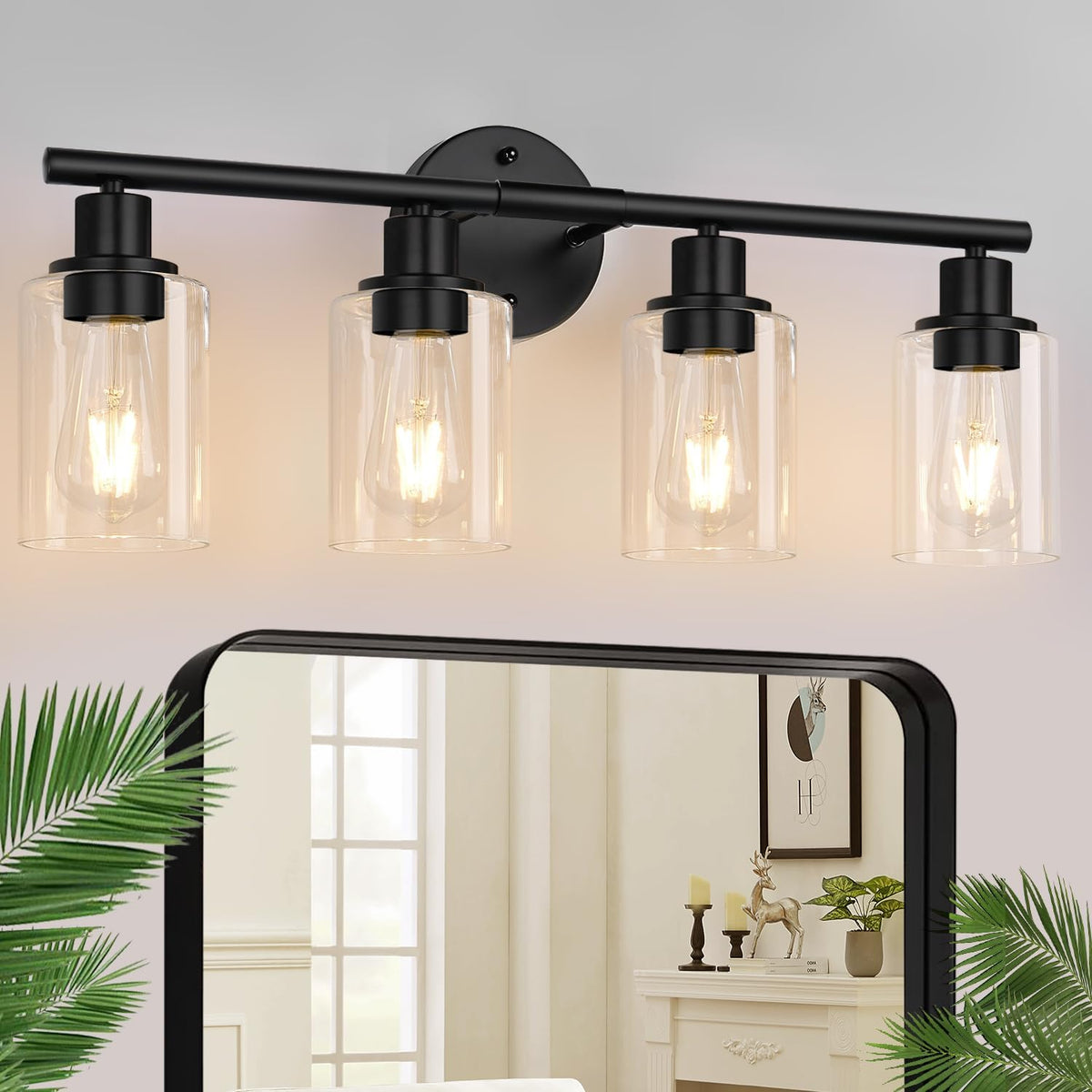 Four-light vanity fixture in matte black with clear glass shades and warm glowing bulbs above a mirror.