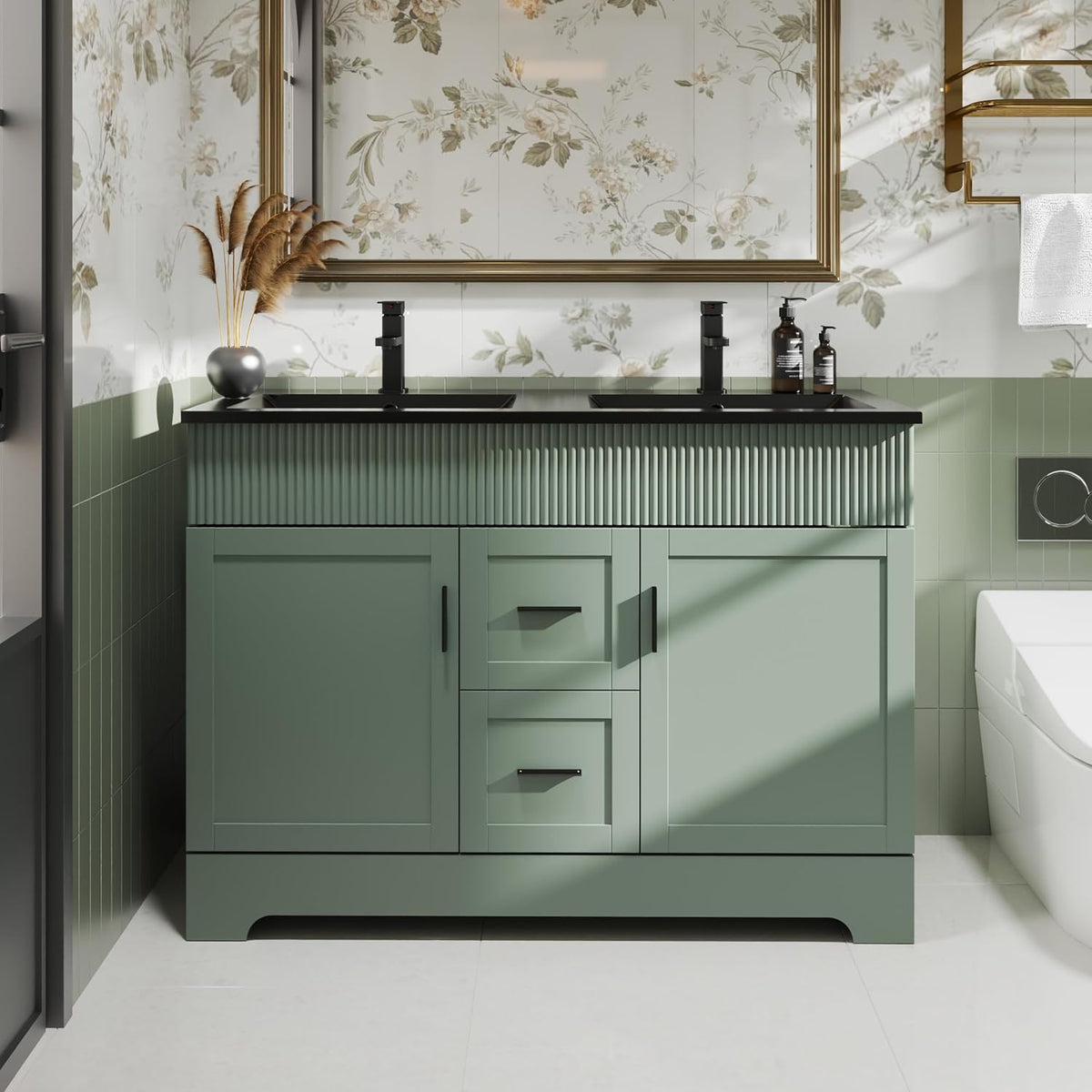 Front view of a green double-sink bathroom vanity with black countertop and two black faucets.