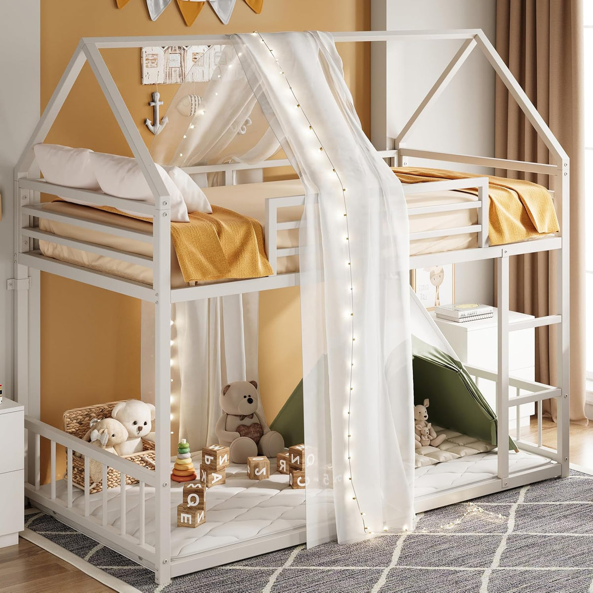 Decorated white bunk bed with sheer canopy drape, string lights and play area underneath with toys and tent.