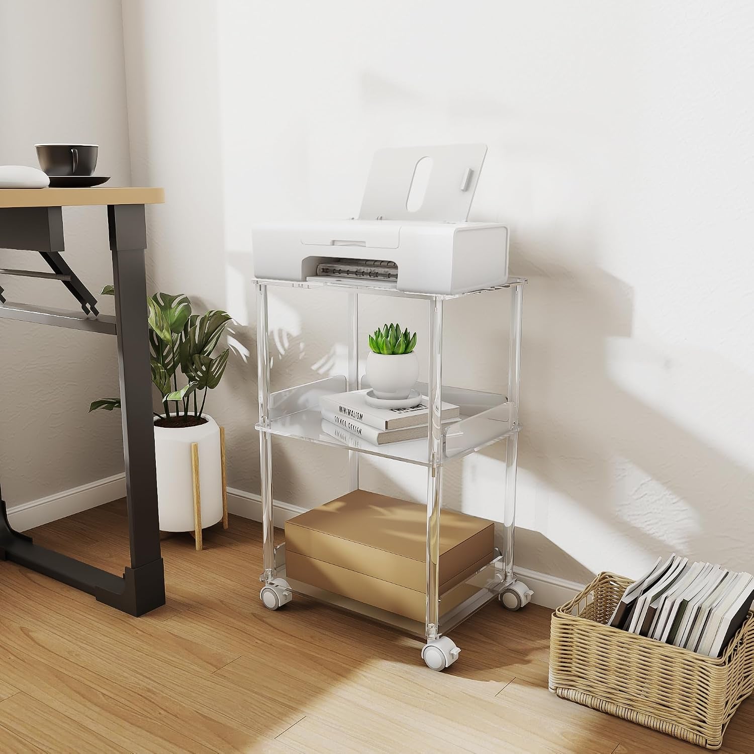 Clear acrylic three-tier stand beside a desk in a bright home office setting with printer on top