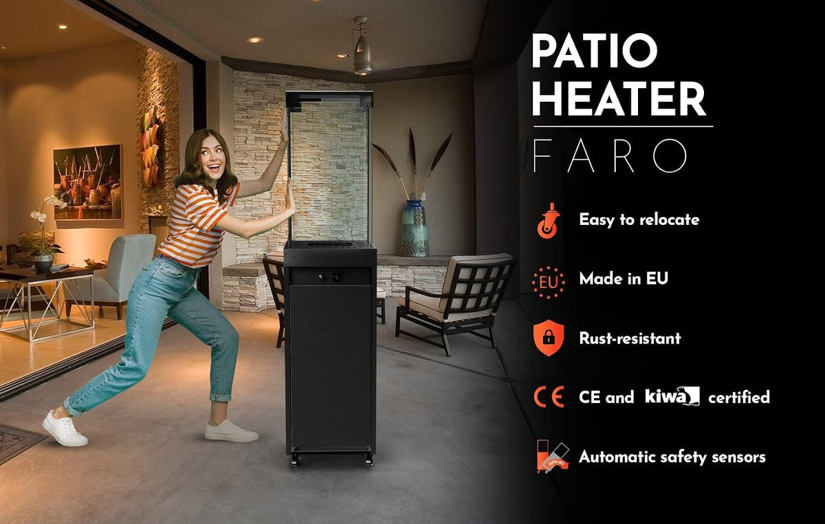 Woman pushing a black glass-topped patio heater in a covered outdoor seating area at dusk.