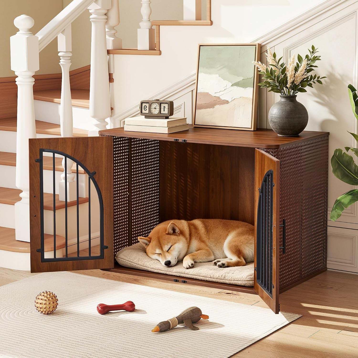 Walnut furniture-style crate placed under stairs with doors open and a sleeping dog inside