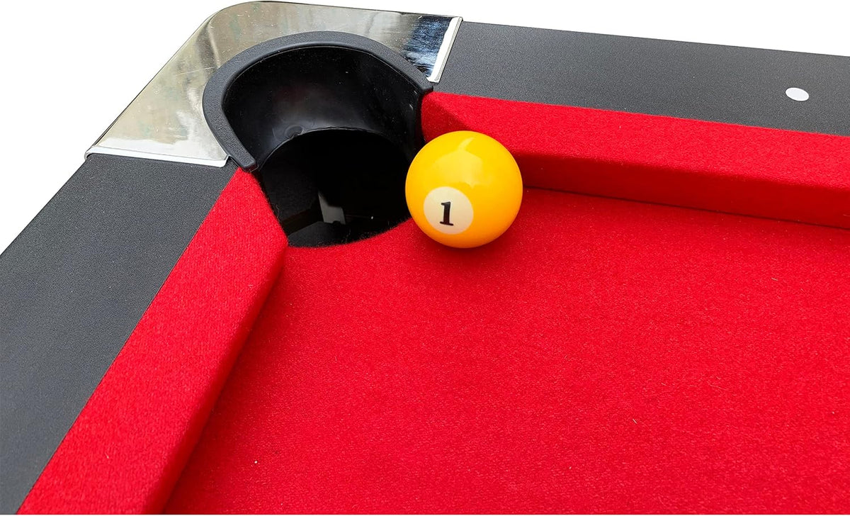 Close-up of a pocket area with red felt and a yellow number 1 billiard ball beside the pocket
