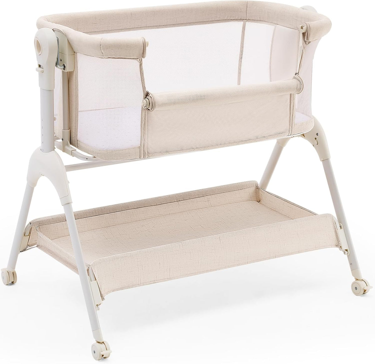 Beige bedside bassinet on white background showing mesh sides, storage shelf and caster wheels.
