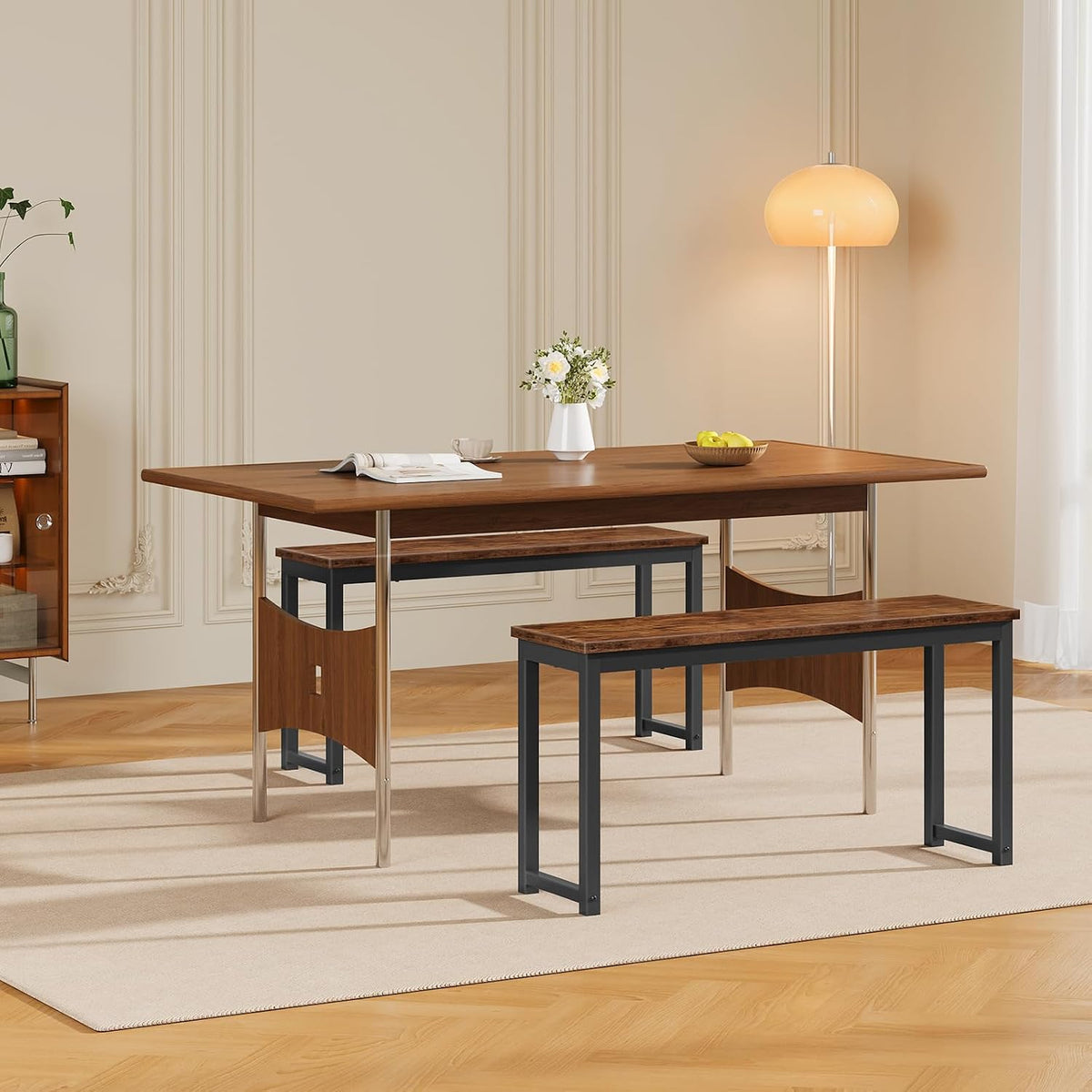 Two rustic brown benches with black metal frames placed under a dining table in a styled dining room setting