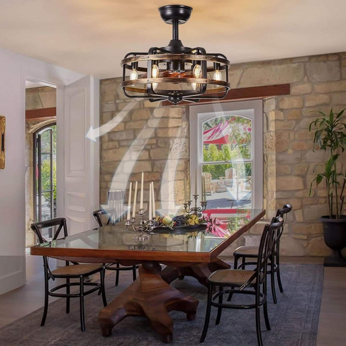 Dining room with a wooden table and chairs beneath a round caged flush-mount ceiling fan with six exposed bulbs.