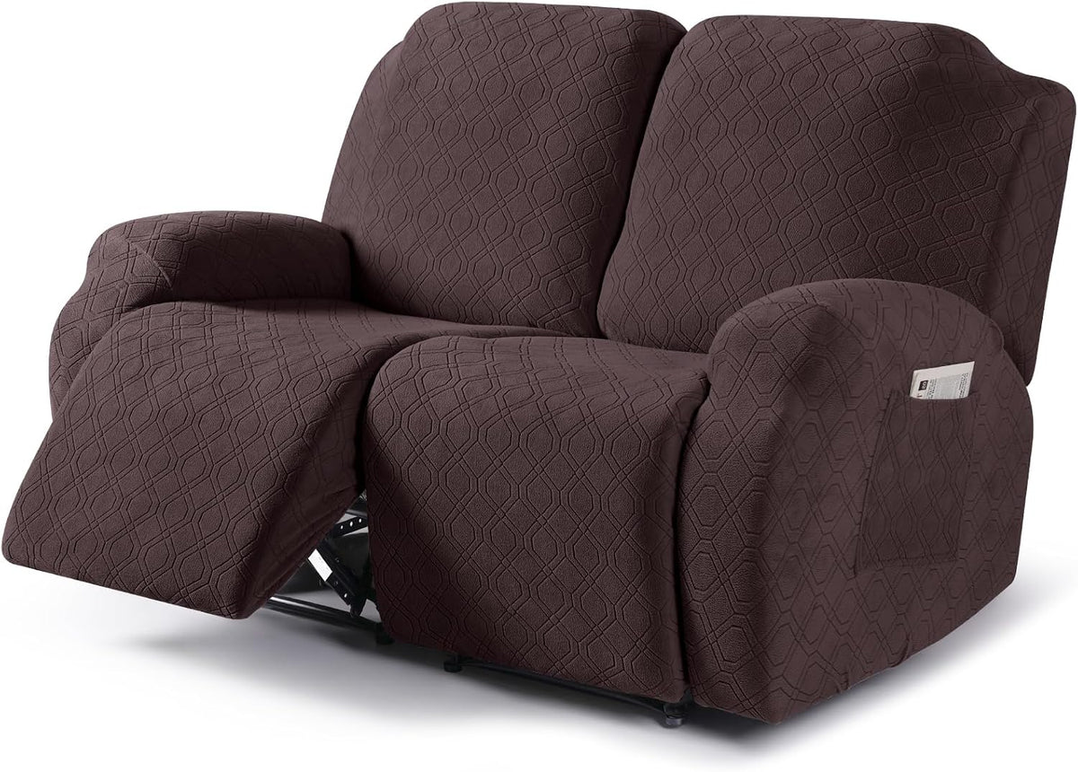 Three-seat reclining sofa with one footrest extended, covered in a dark brown textured slipcover with pocket on the arm.