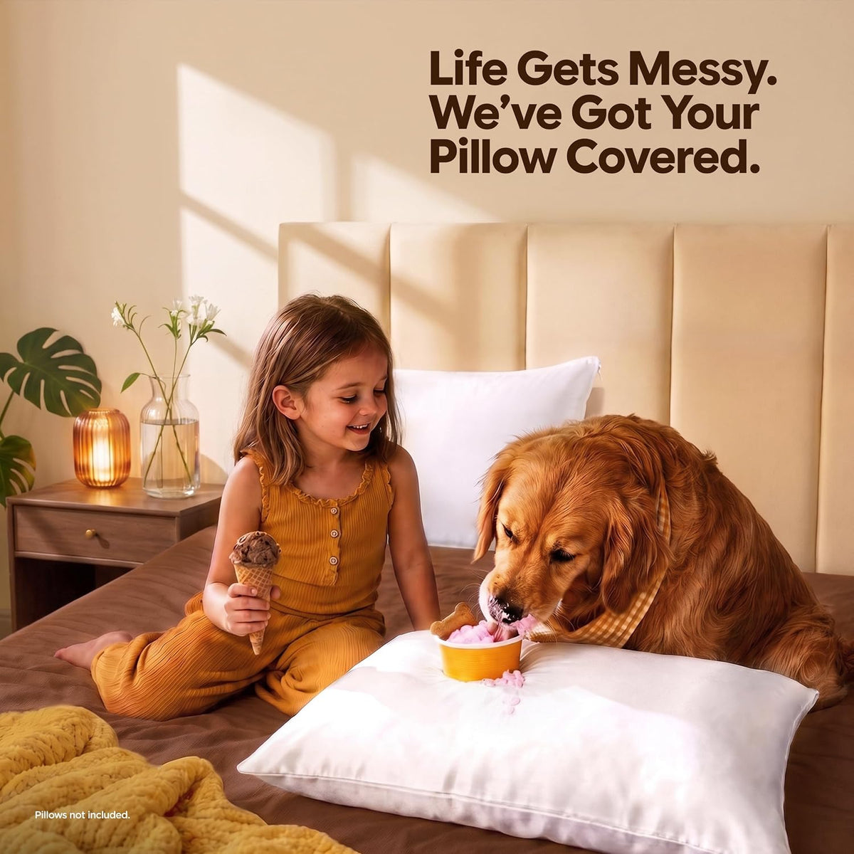 Child on a bed smiling as a golden retriever licks food from a bowl placed on a white zippered pillow protector.