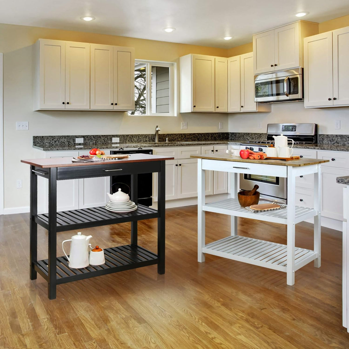 Wide kitchen scene showing two islands side by side: one black and one white with wood tops in a finished kitchen.