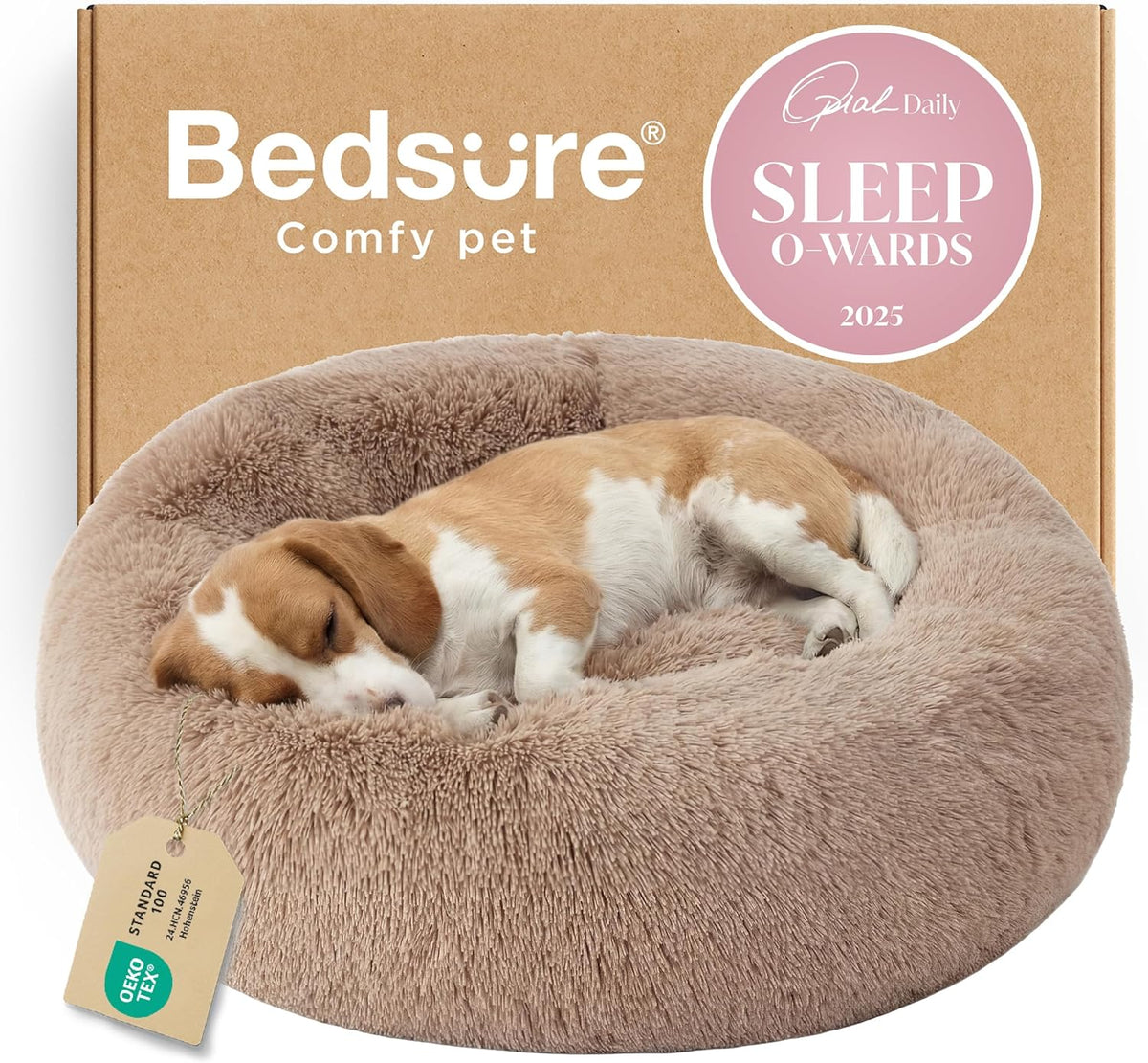 Slightly elevated view of a tan fluffy donut bed with a sleeping beagle and a product tag draped over the rim.