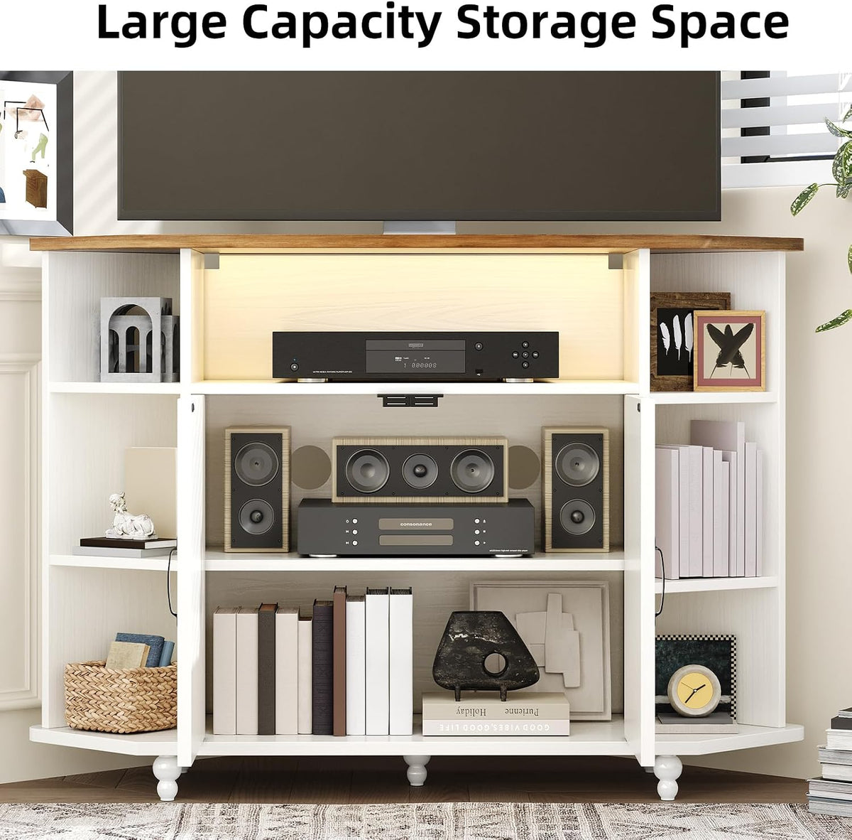 Interior view of stand showing open center shelf, lower equipment shelf and side cubby storage with books and decor