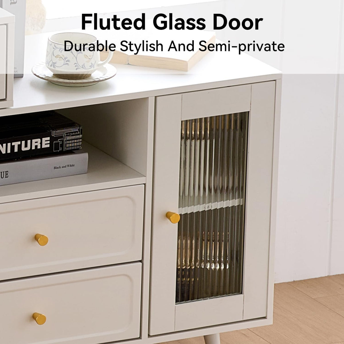 Close-up of a bedside cabinet showing two drawers with round gold knobs and a fluted glass door.