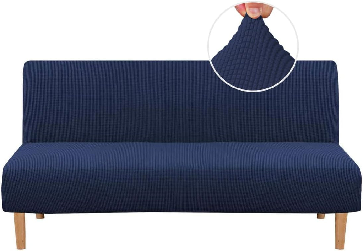 Front view of a navy blue small-check textured slipcover on a low-profile futon with wooden legs.