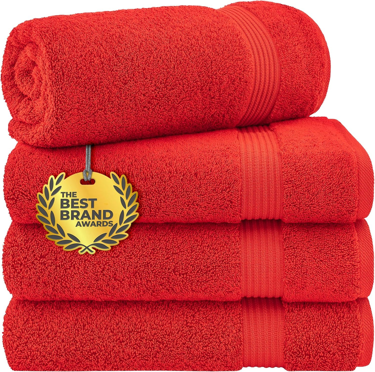 Stack of bright red towels with a rolled towel perched on top showing textured edges