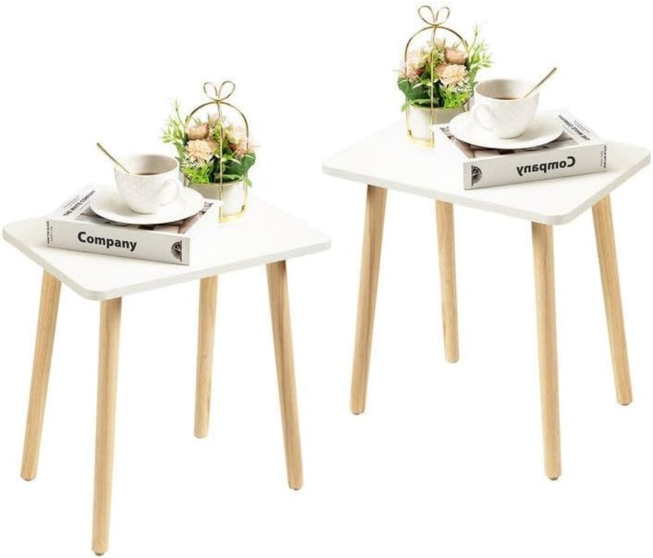 Two small white square side tables with light wood legs, each styled with a cup and small plant