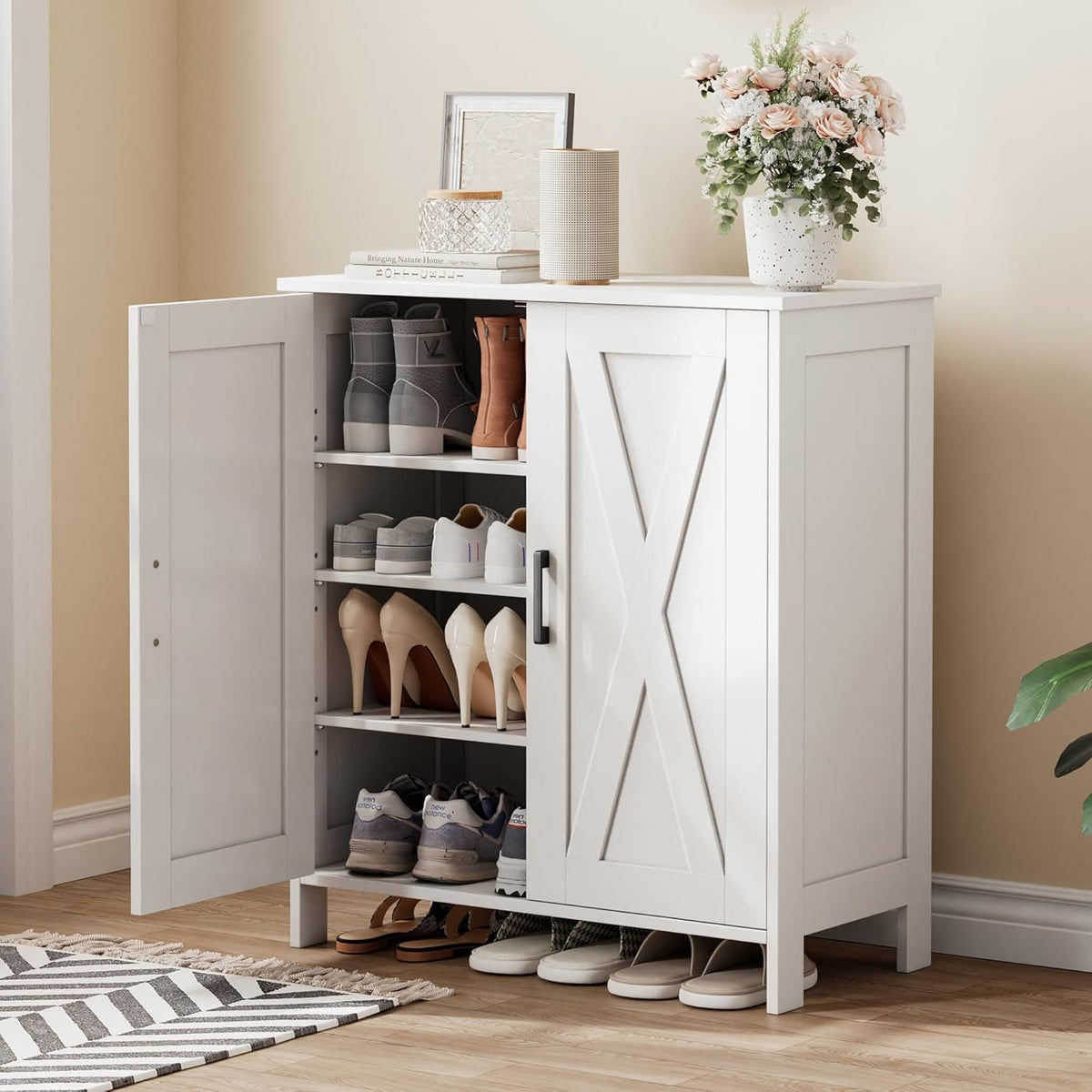 White shoe cabinet with X-panel barn doors, one door open revealing shoes on shelves, angled front view
