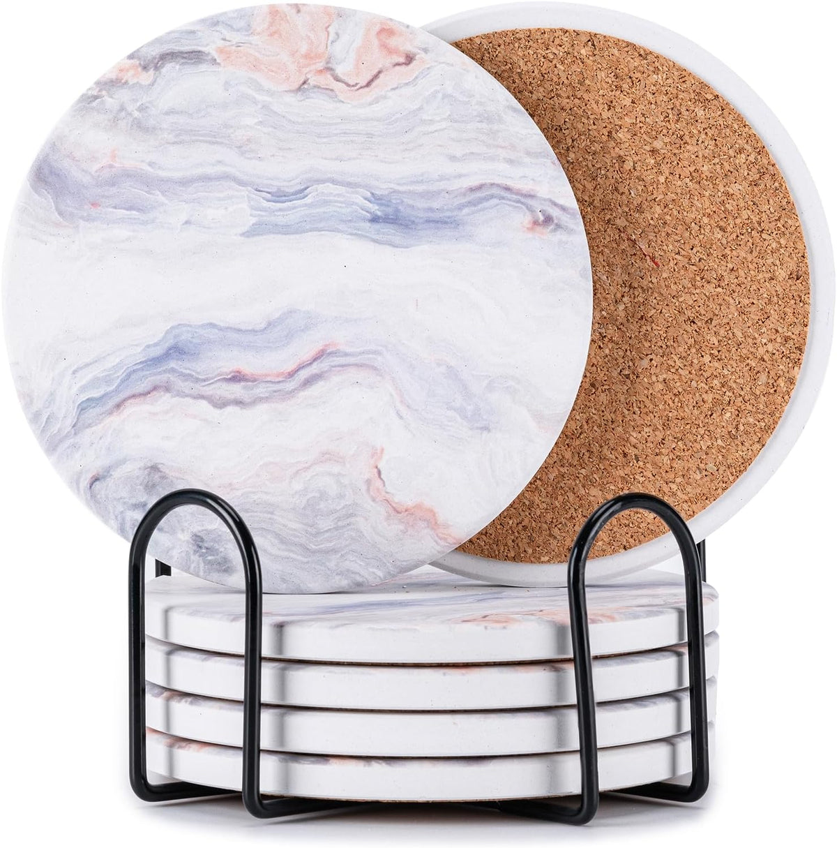 Close view of light marble-pattern coasters with subtle pink accents stacked in a black holder showing cork back.