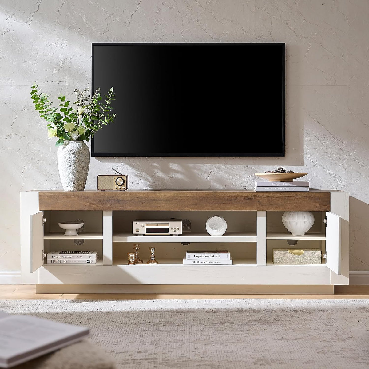 Antique white TV stand with side cabinet doors open beneath a TV