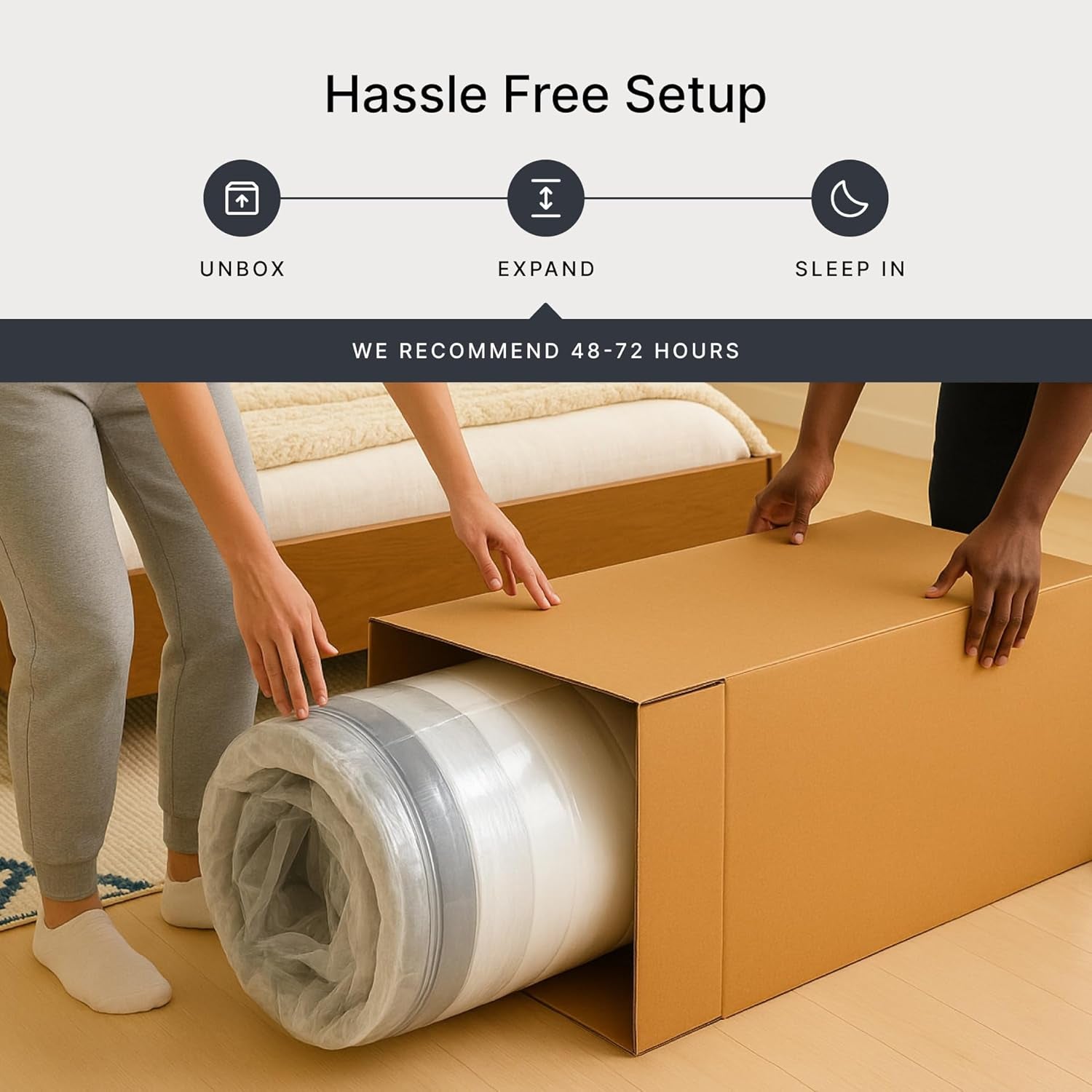 Two people unboxing a rolled, compressed mattress from a cardboard box on a bedroom floor