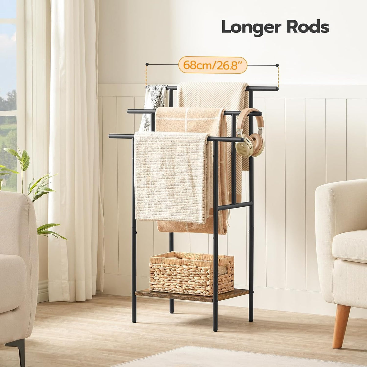 Top section of the towel rack showing three staggered black metal bars with towels in a bright room setting.