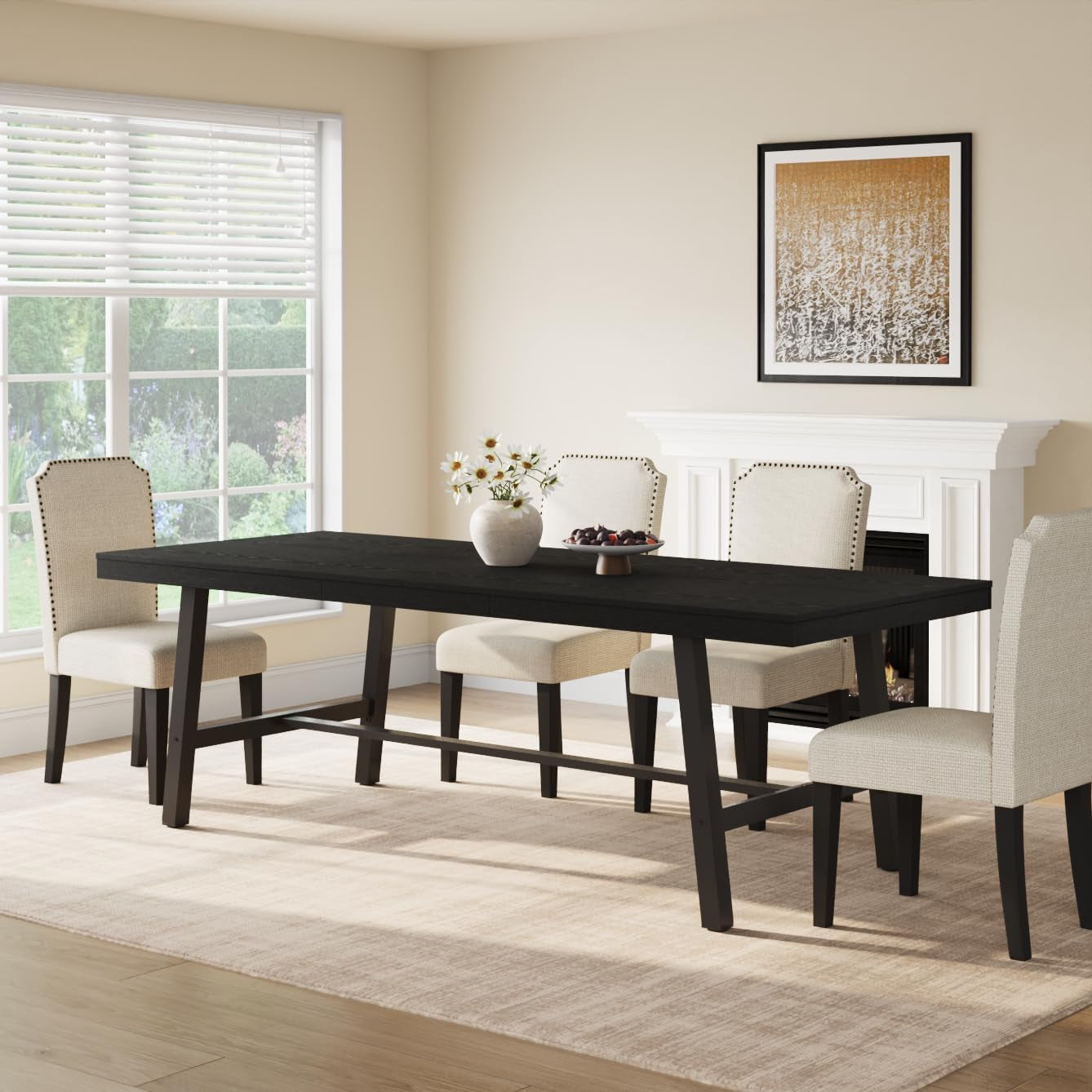 Long black tabletop with angled metal legs set with four upholstered dining chairs near a window