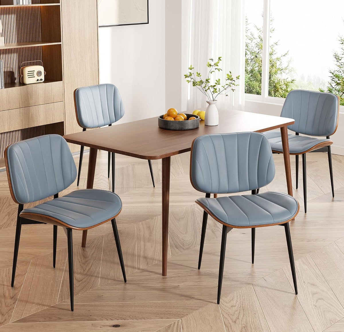 Dining table with six mid-century chairs in muted blue faux leather and walnut backs around a wooden table