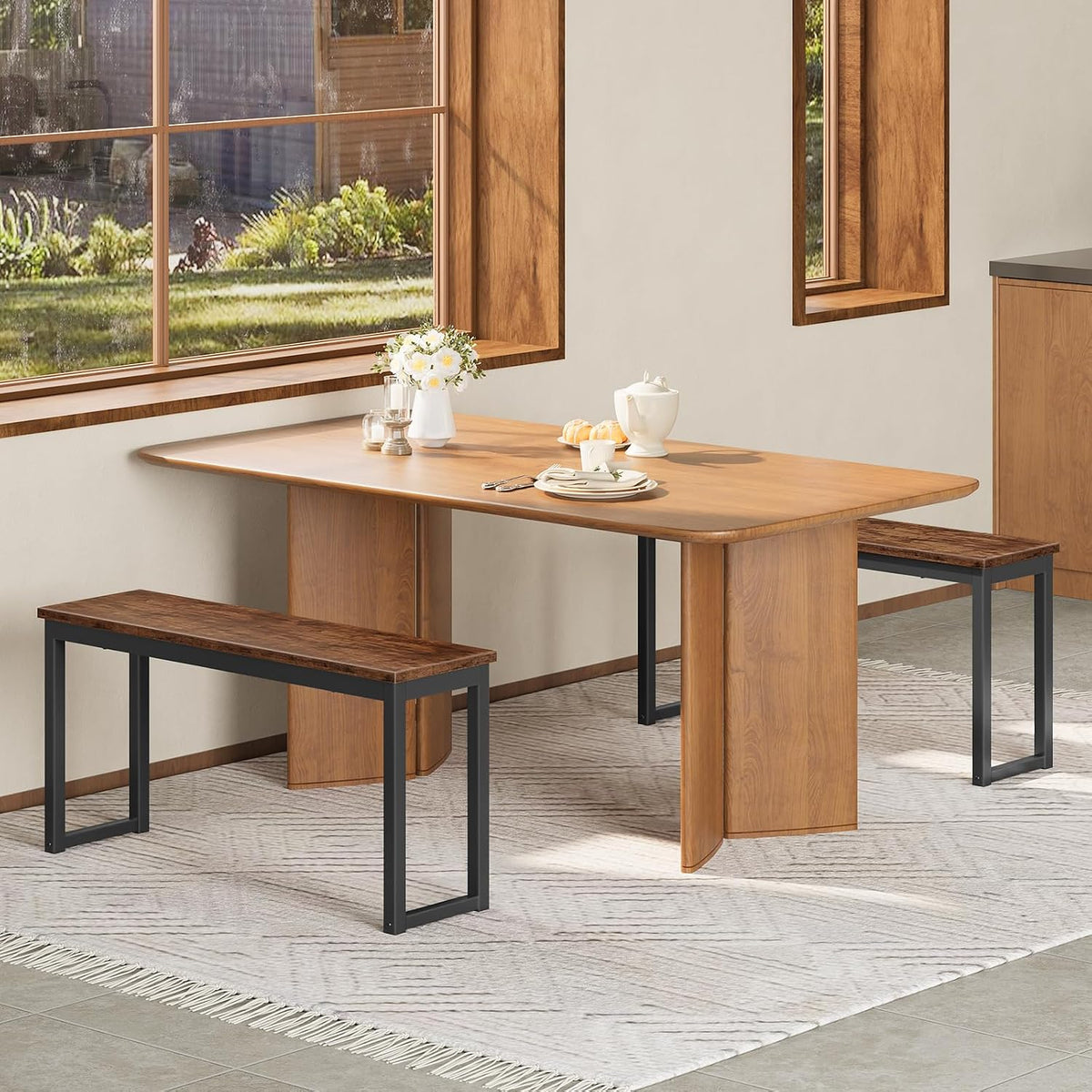Two benches flanking a long wooden dining table near large windows, one bench pushed in under the table.
