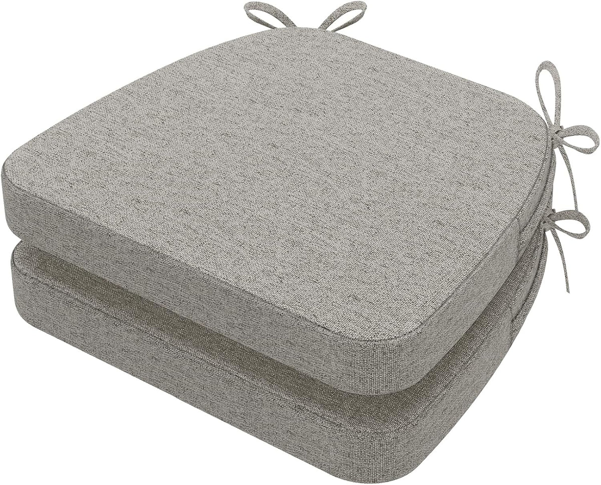 Two gray D-shaped chair cushions stacked neatly, top cushion showing tied loops at rear corner