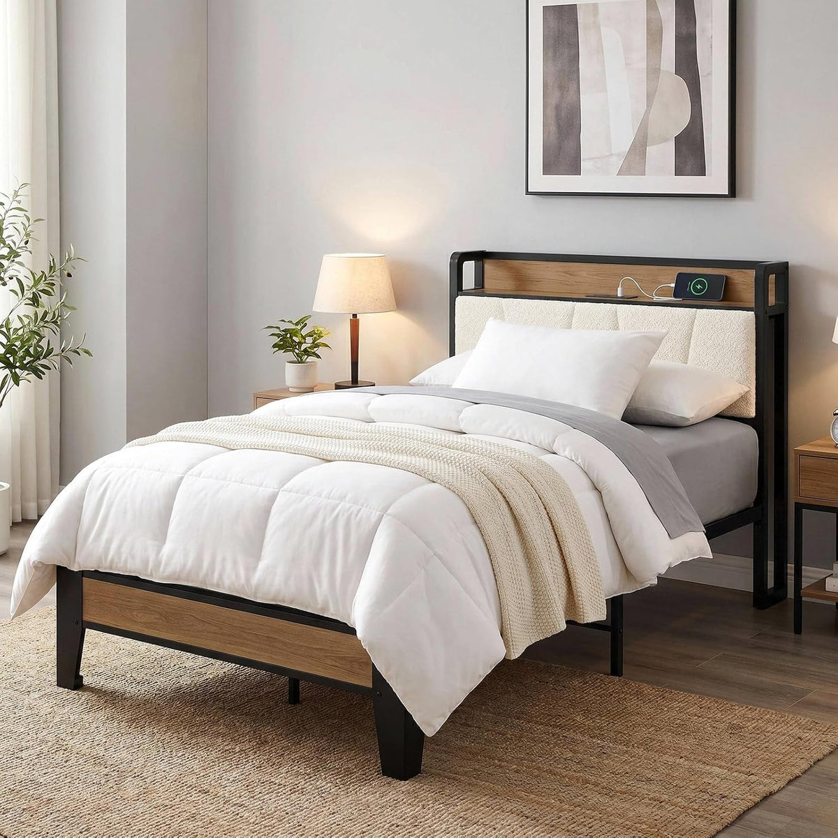 Angled bedroom view of a bed with cream upholstered headboard, wood accent panels and black metal frame.