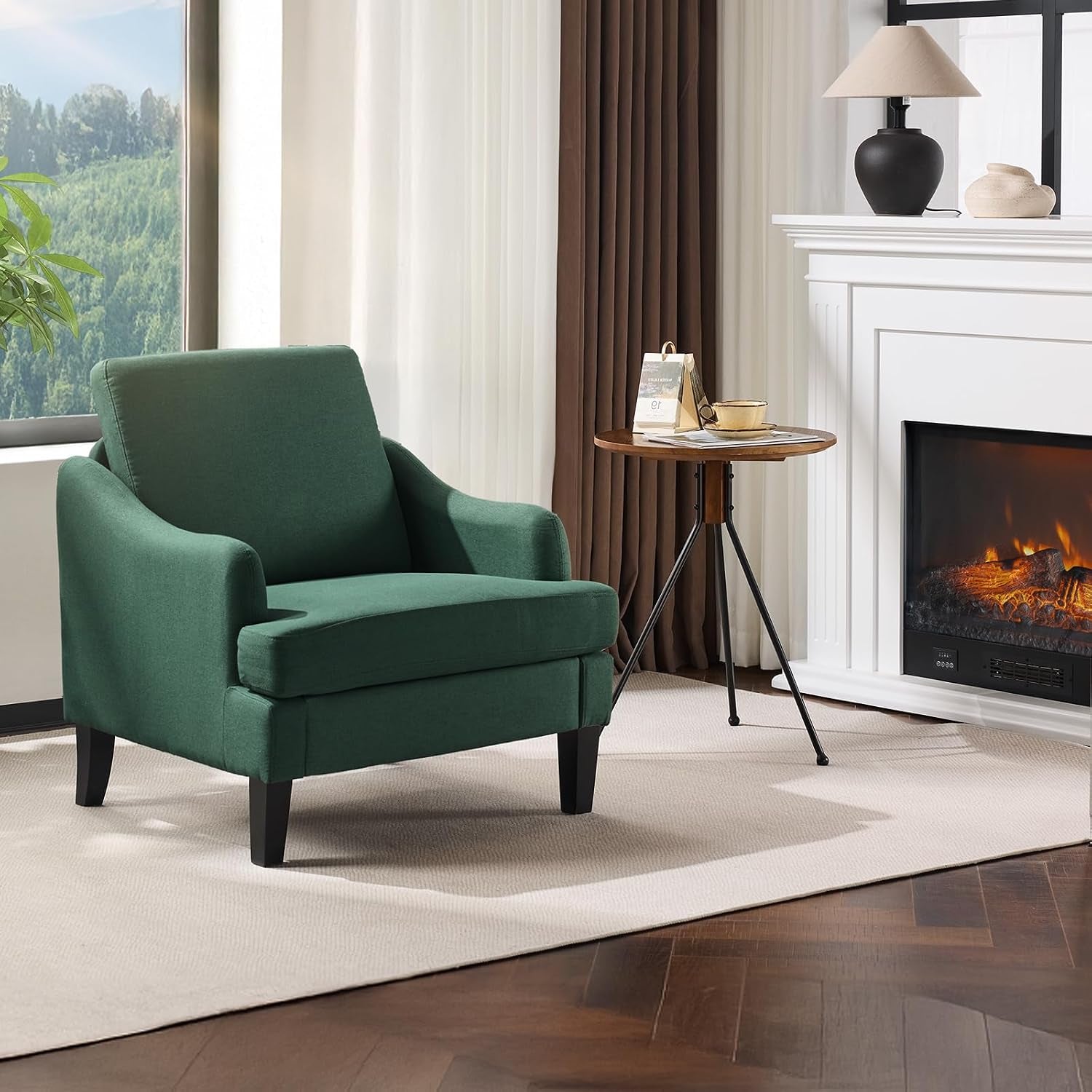 Single deep green upholstered armchair positioned next to a tripod side table and fireplace.