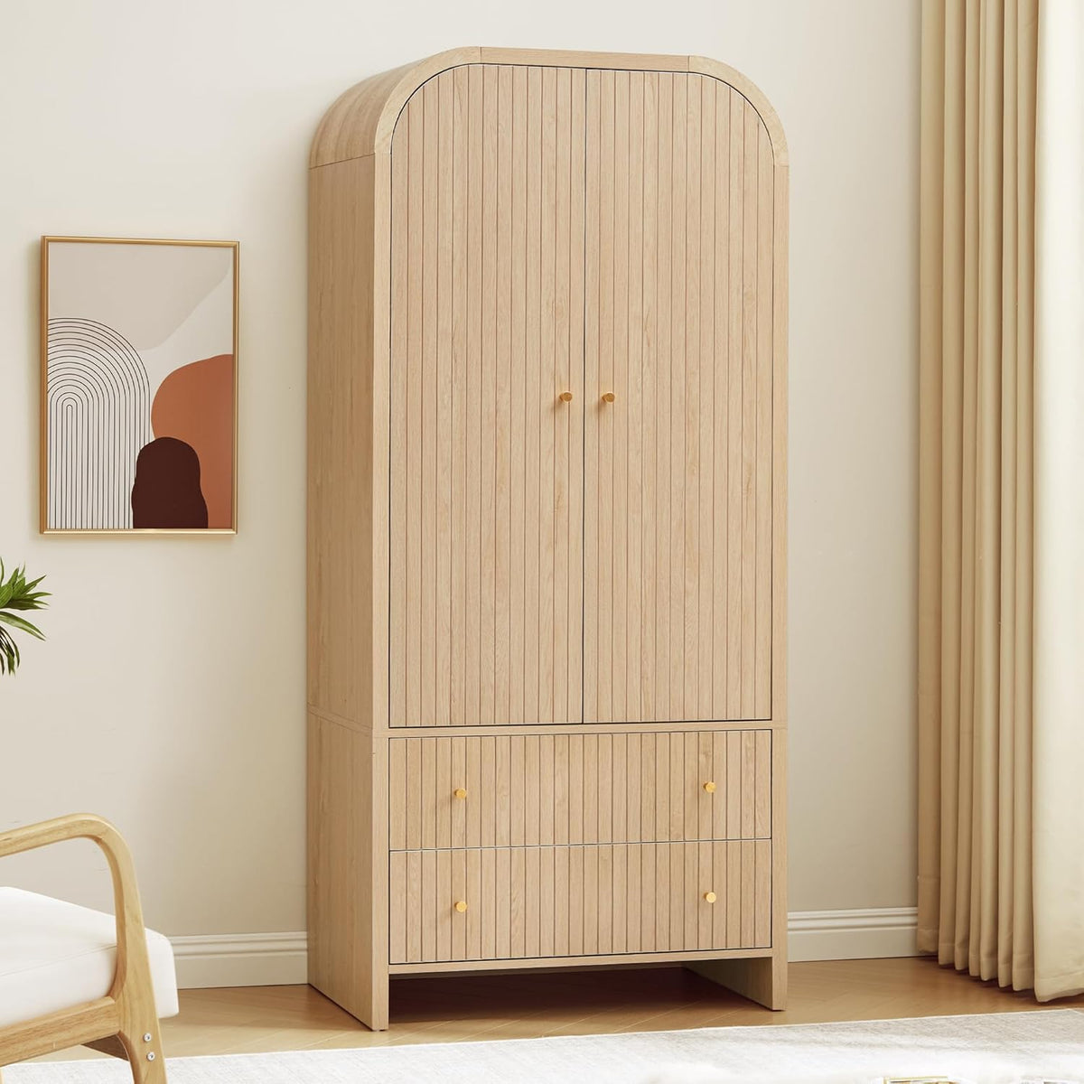 Tall arched two-door wardrobe in walnut with two lower drawers standing against a bedroom wall