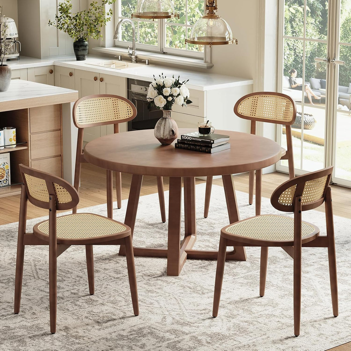 Kitchen dining scene with round table and four walnut-finish cane-back chairs near a window.