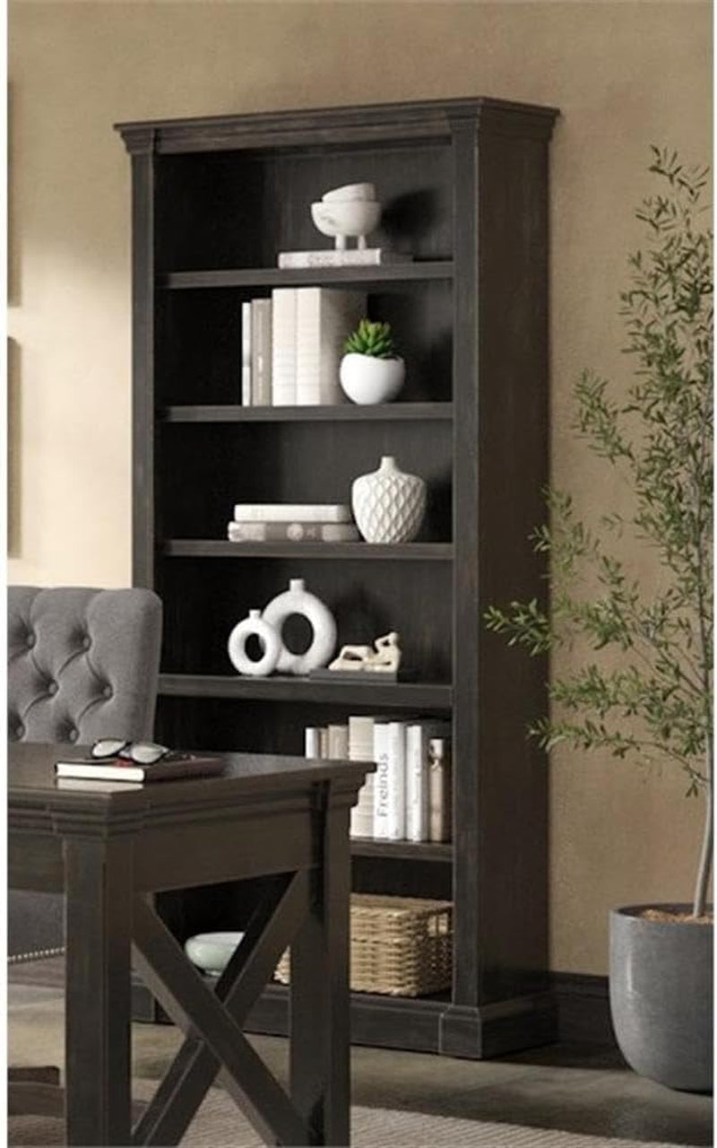 Distressed dark brown open bookcase with multiple shelves staged beside a desk in a room