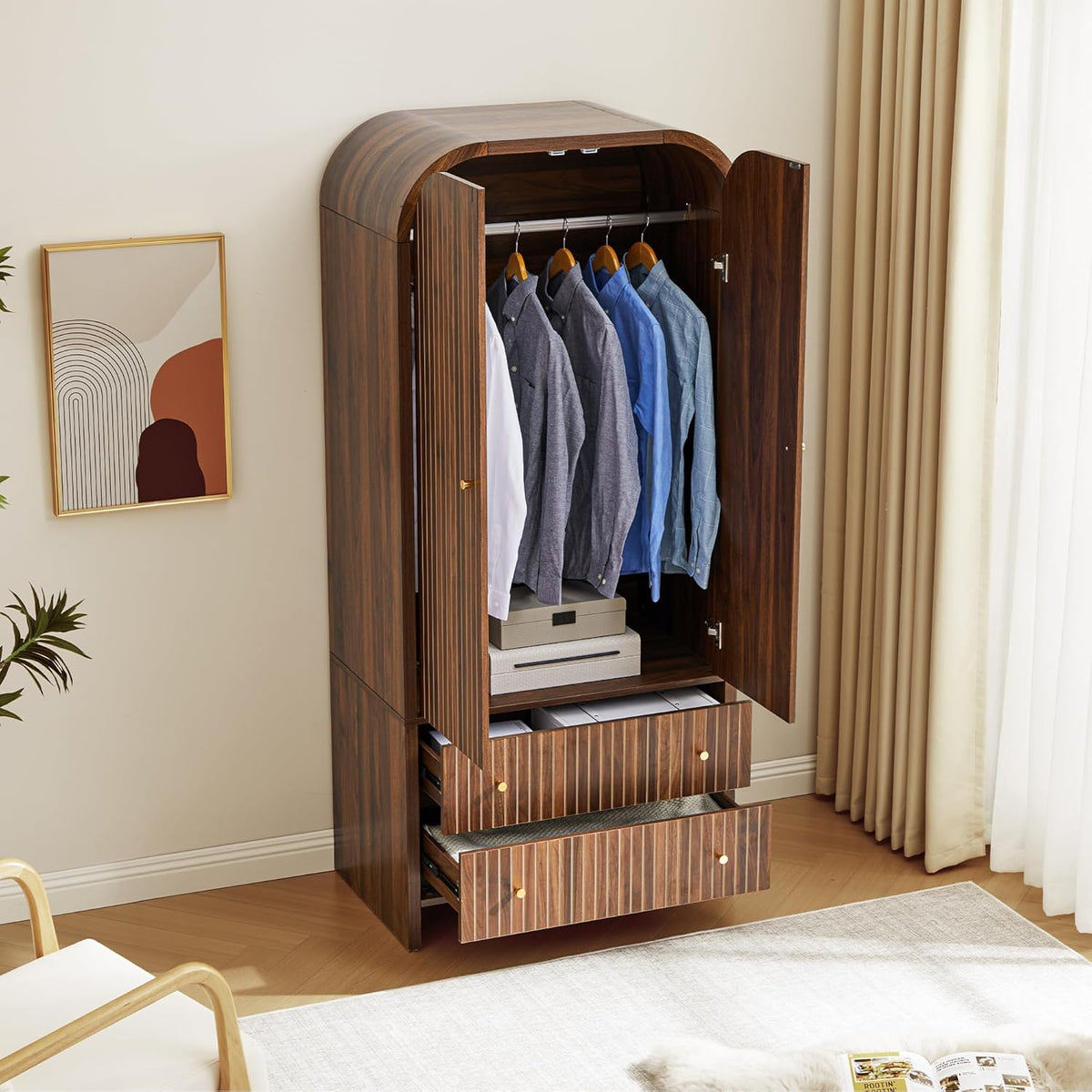 Interior view of the armoire with doors open showing hanging rod with shirts and the two lower drawers partially open