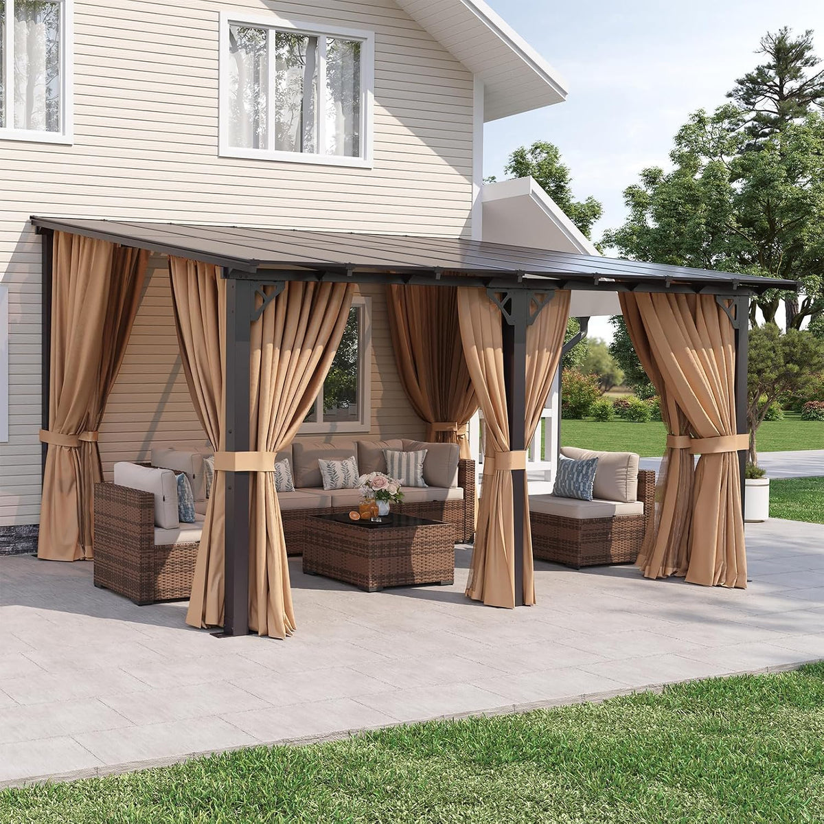 Wide daytime shot from the lawn showing the full attached pergola with curtains tied to dark metal posts