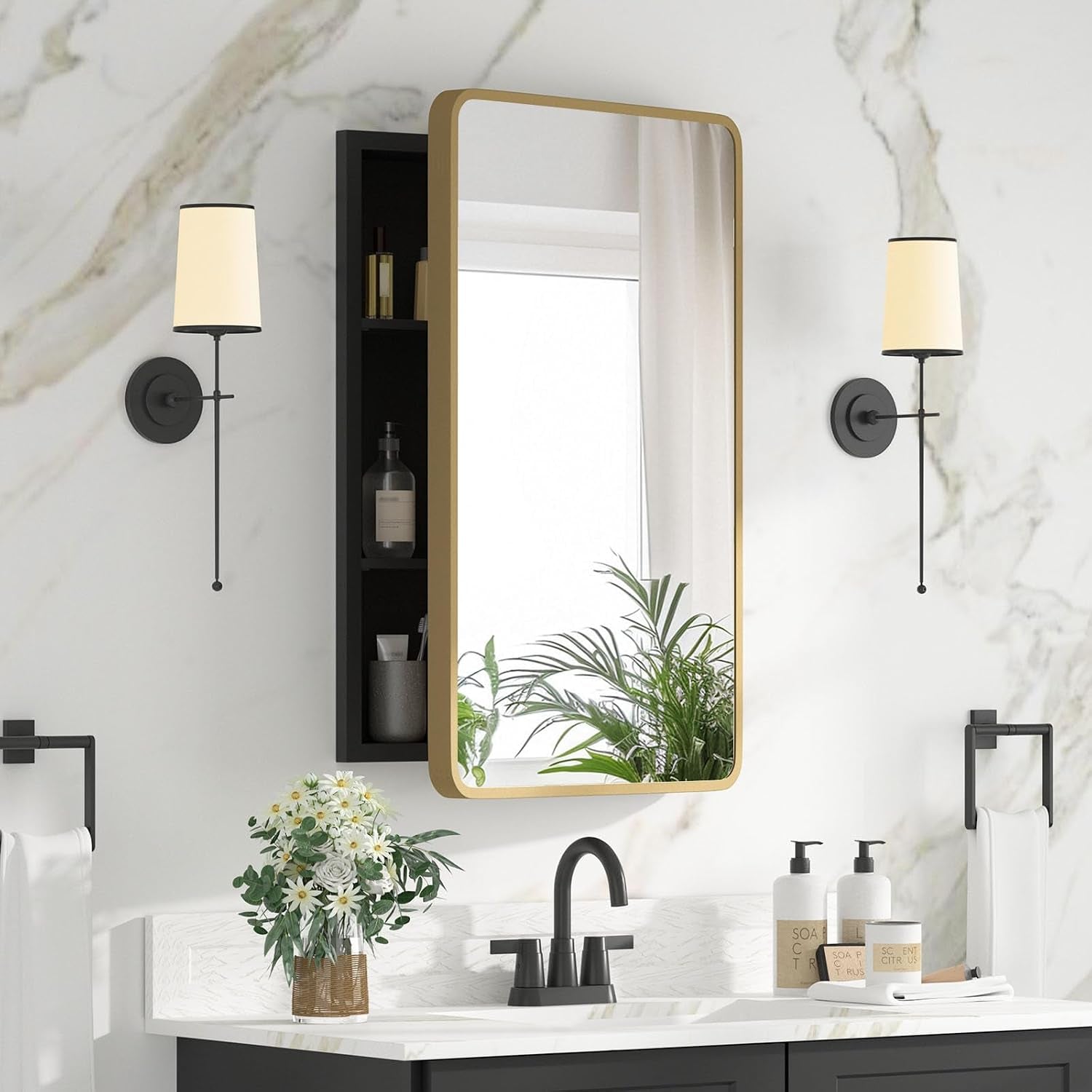 Single-door gold-framed mirrored cabinet shown slightly open to reveal dark interior shelving beside sink.