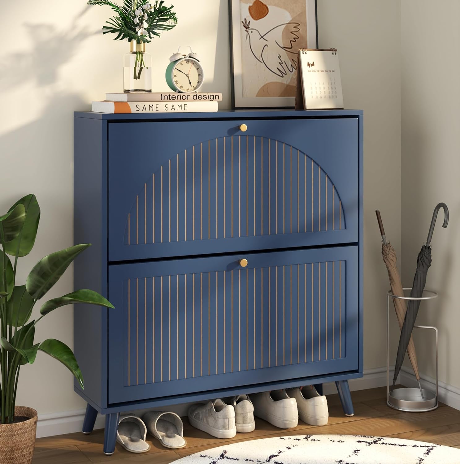 Blue shoe cabinet close-up with semi-circle fluted detail on the top flip drawer and gold knobs