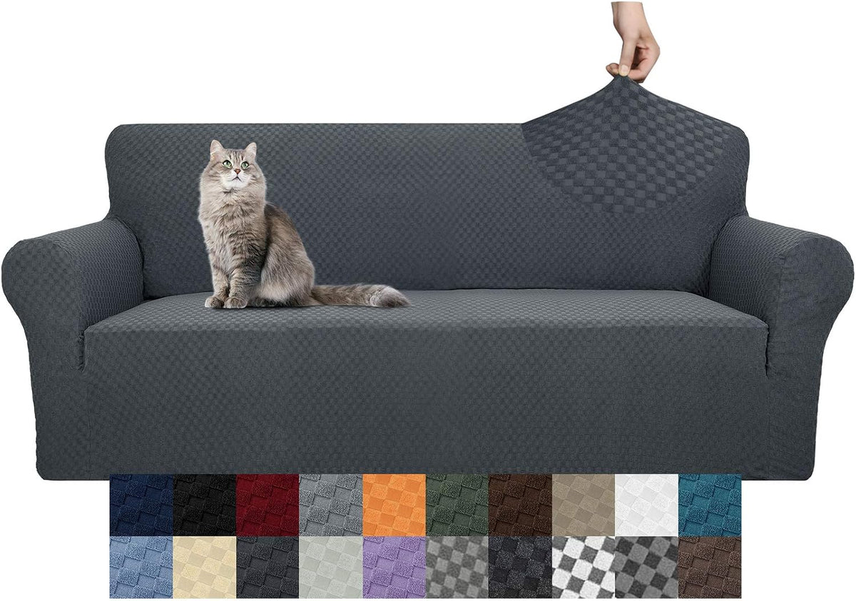 Gray textured slipcover on sofa with a cat sitting on the seat and a hand stretching fabric at the back