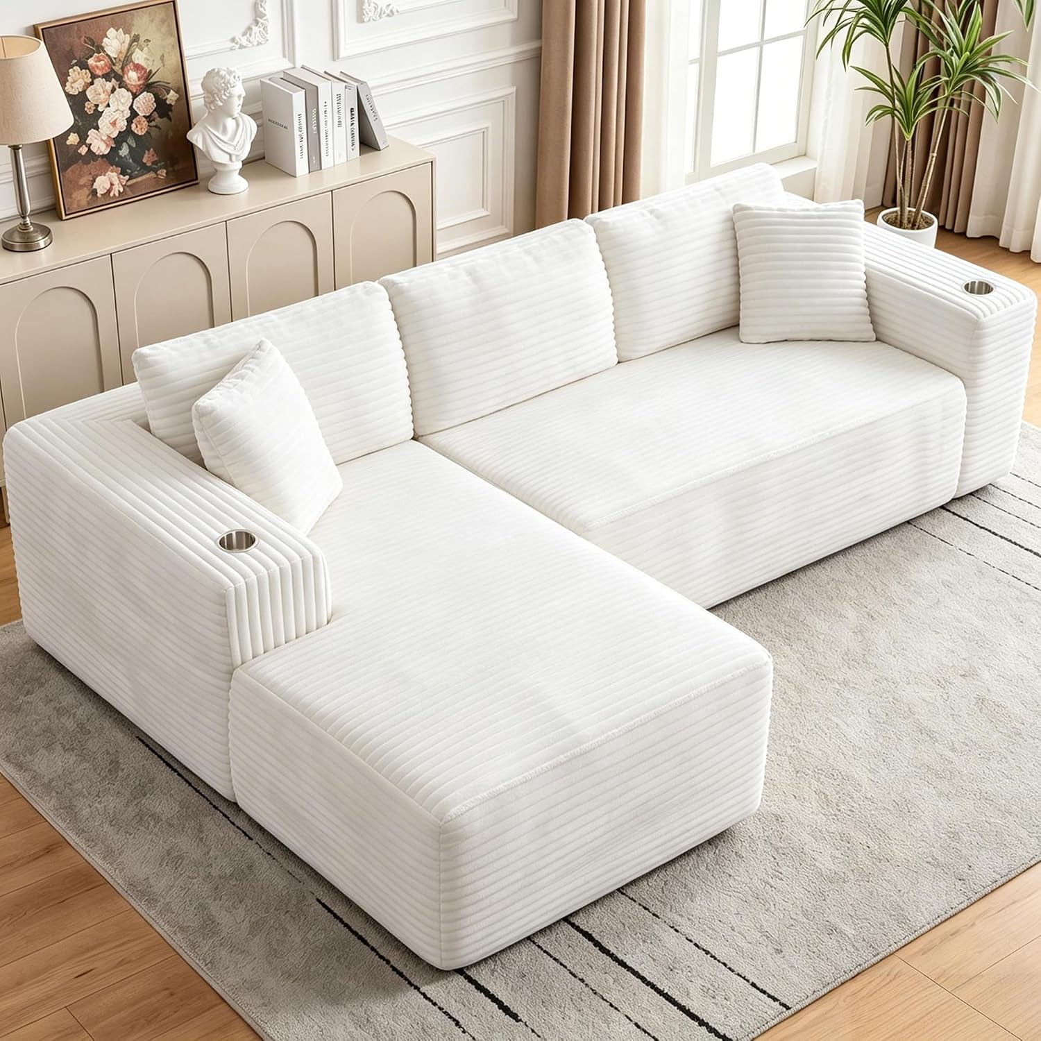 Angled view of the same modular sectional in white corduroy with chaise positioned left.
