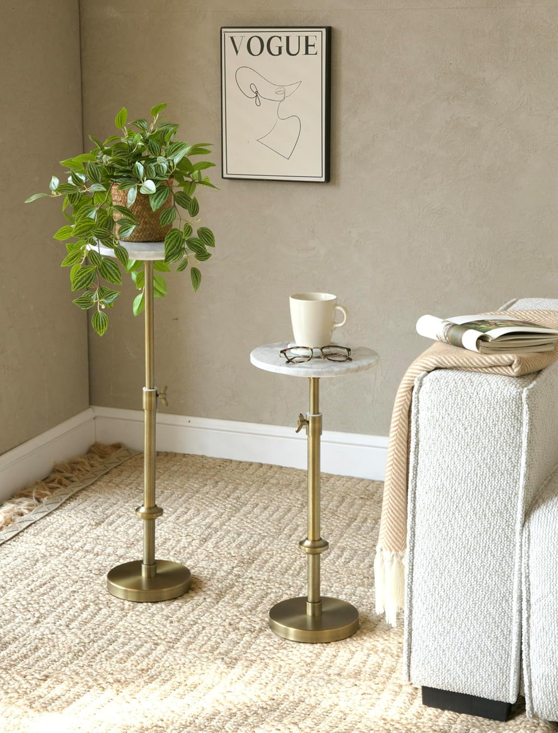 Two pedestal tables at different heights, one used as a plant stand and one as a drink table