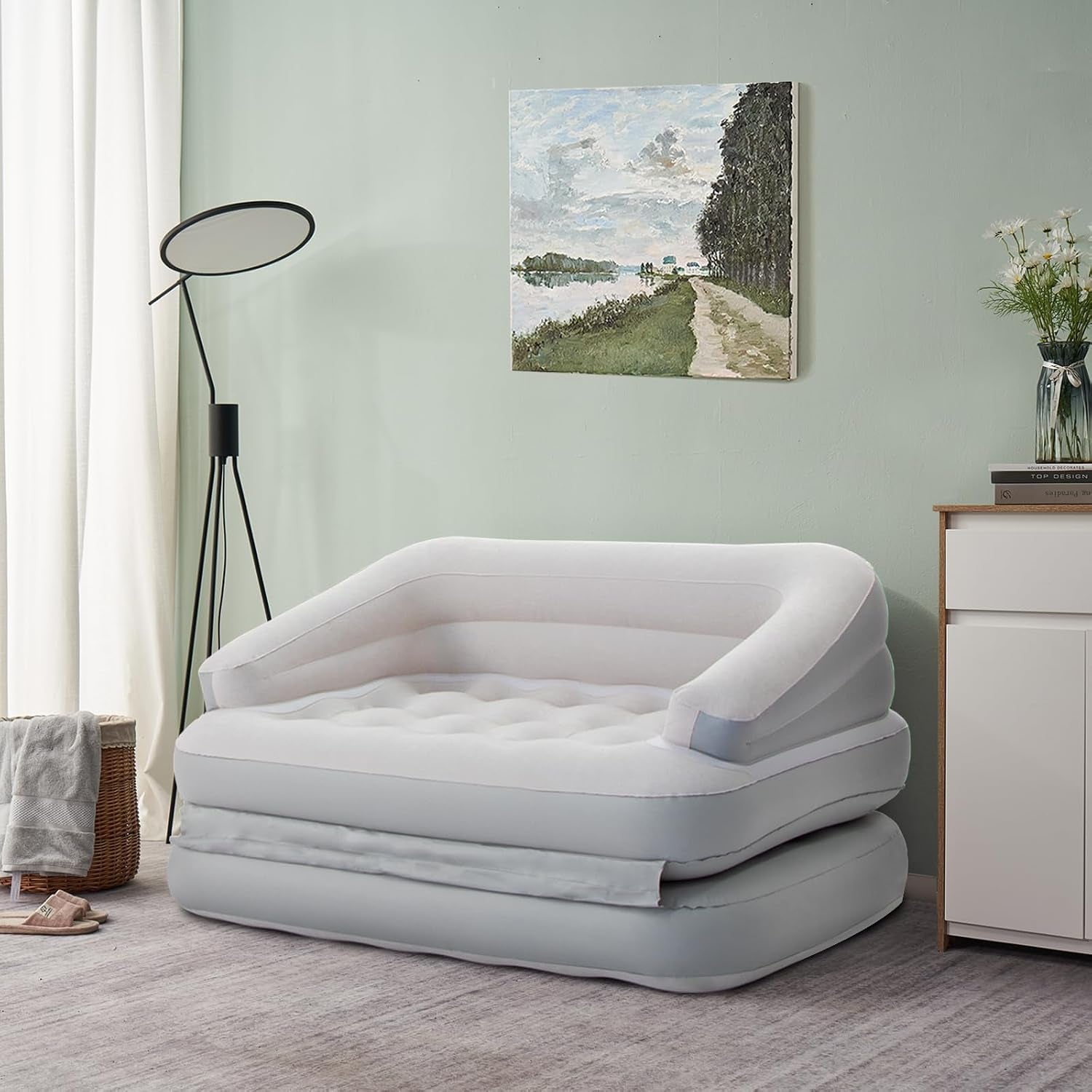 White inflatable sofa bed styled in a living room setting with backrest and armrests visible