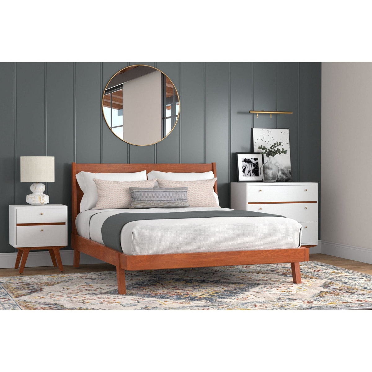 White chest with acorn accents beside a bed in a styled bedroom