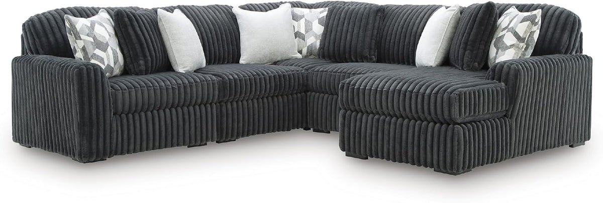 Corner perspective of a dark charcoal oversized chaise section highlighting rounded arm corners and plush ribs.