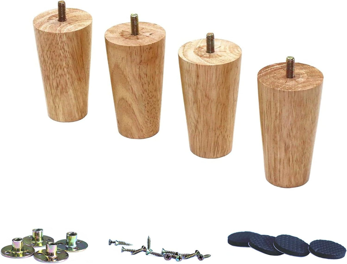Close cropped view of four tapered wood legs standing in a row with mounting plates, screws, and round black pads below