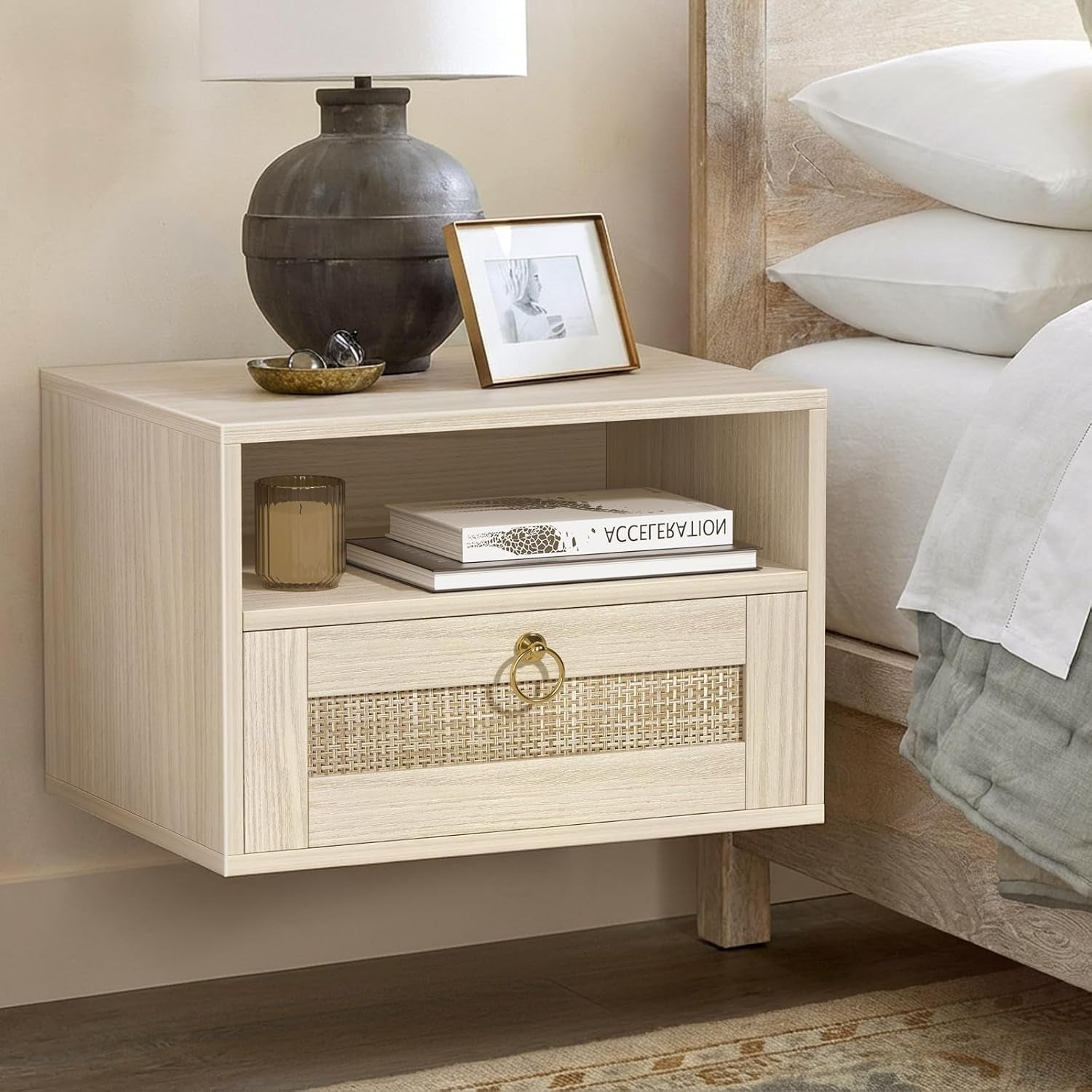 Close-up of the floating nightstand showing the open cubby with stacked books and a lamp and decorative dish on the top