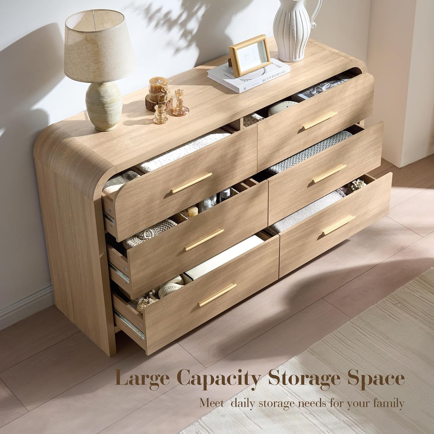 Angled top view of the 6-drawer dresser with several drawers open showing internal storage and gold handles