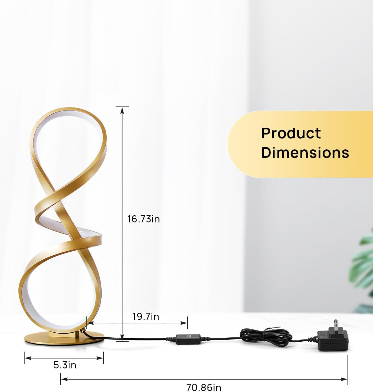 Front view of the gold spiral lamp with measurement arrows and its power cord stretched across the table.